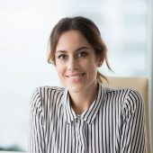 Portrait of smiling confident female boss looking at camera